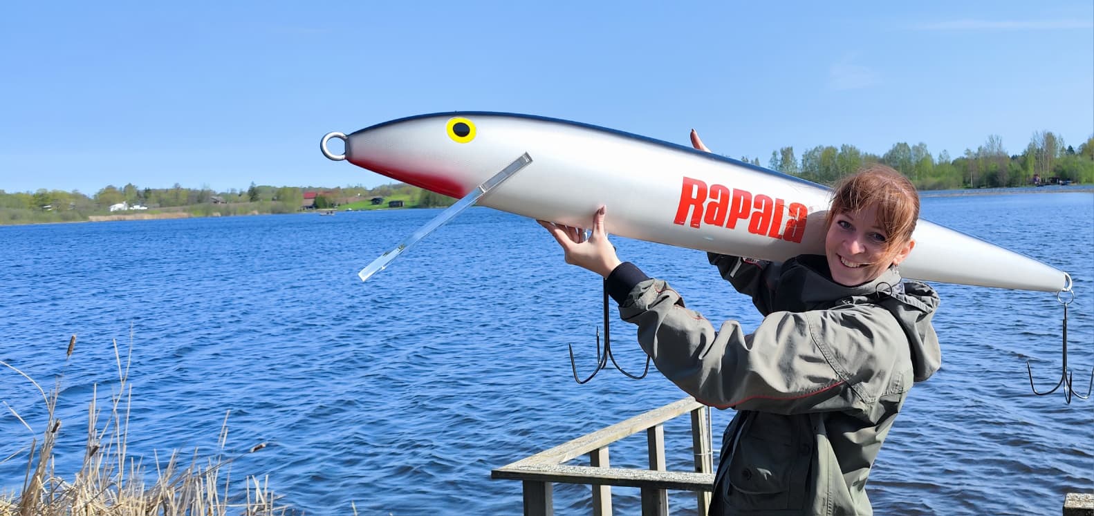 Elīna with a giant Rapala lure by a Latvian lake